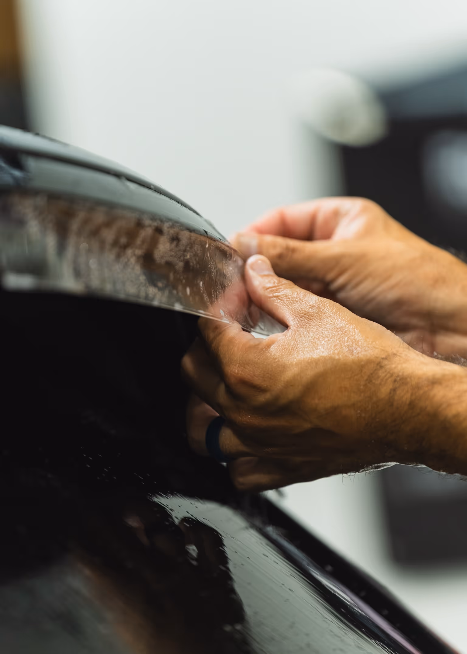 Hand-applying paint protection film to a panel edge