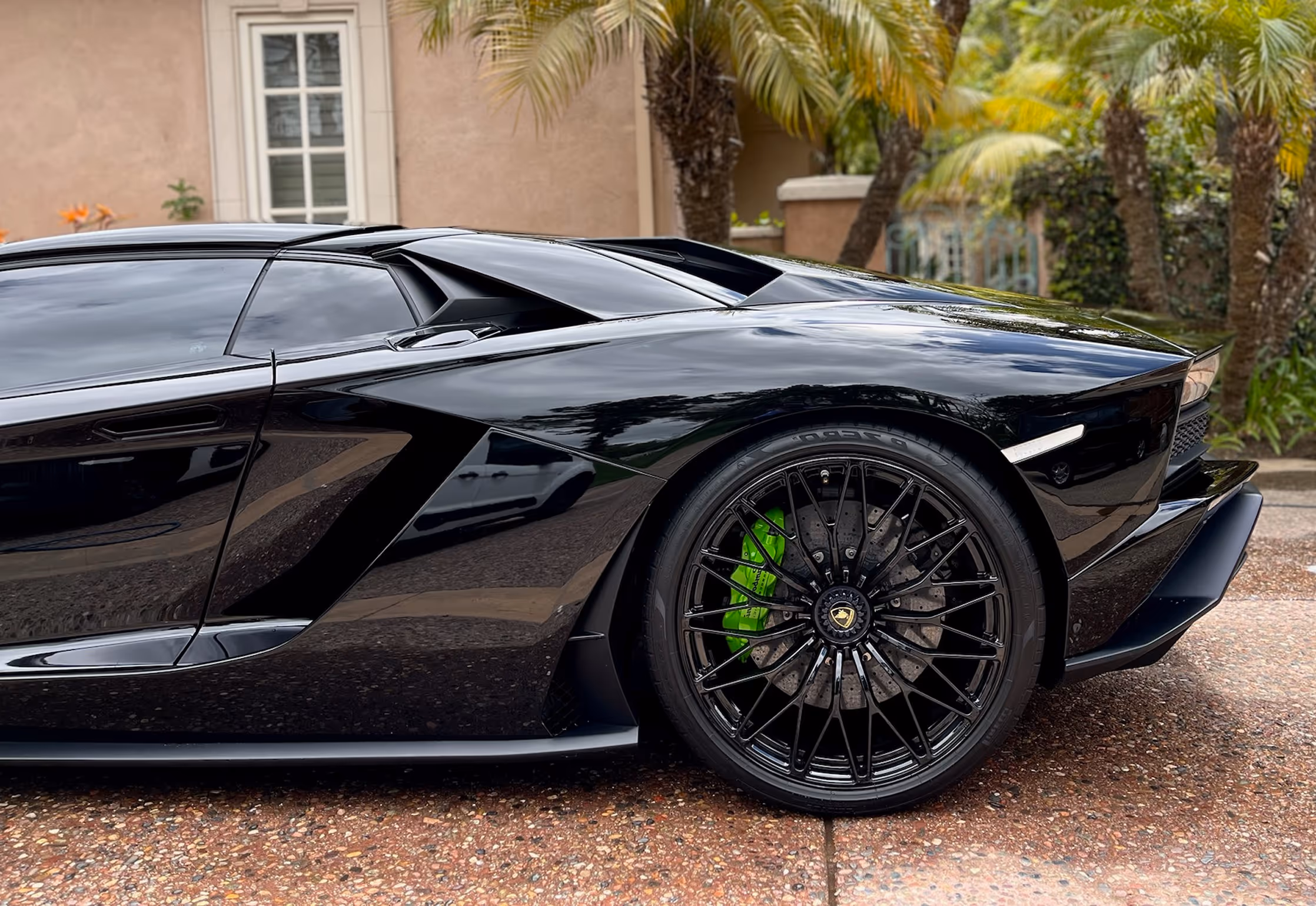 Dark colored sports car showing a deep reflective paint finish